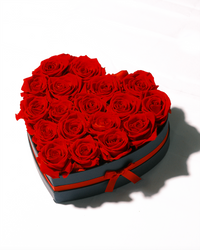 Eighteen red preserved roses in a heart-shaped box
